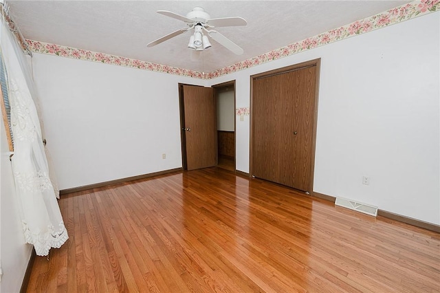 unfurnished bedroom featuring ceiling fan and hardwood / wood-style floors