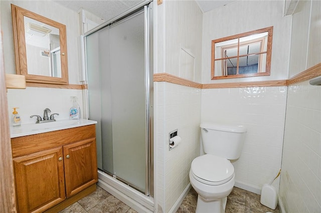 bathroom with vanity, toilet, and an enclosed shower