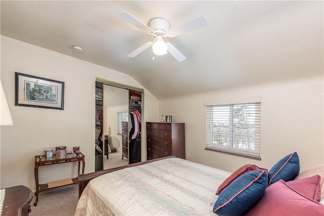 carpeted bedroom featuring vaulted ceiling, a closet, and ceiling fan