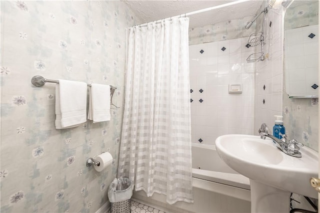 bathroom featuring a textured ceiling, tile patterned flooring, and shower / bath combo