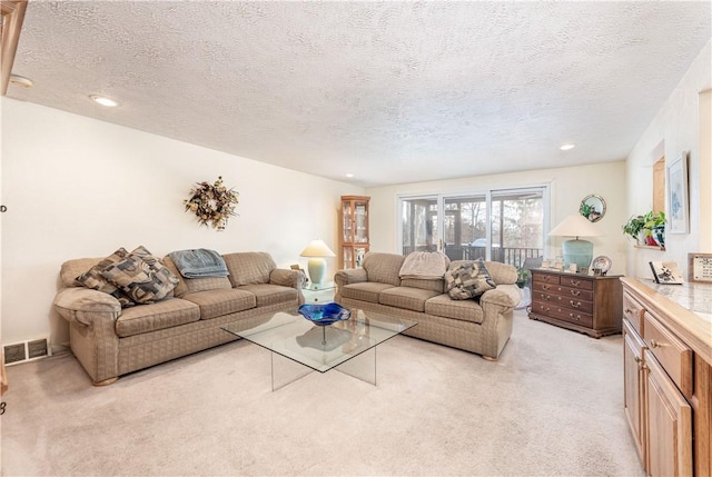 living room featuring light carpet and a textured ceiling