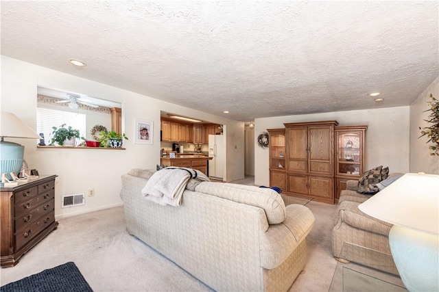 carpeted living room featuring a textured ceiling