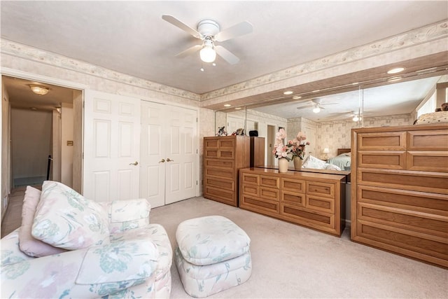 sitting room featuring light carpet and ceiling fan