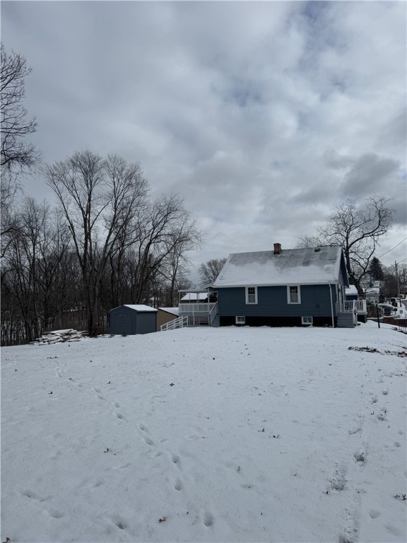 snowy yard with a shed