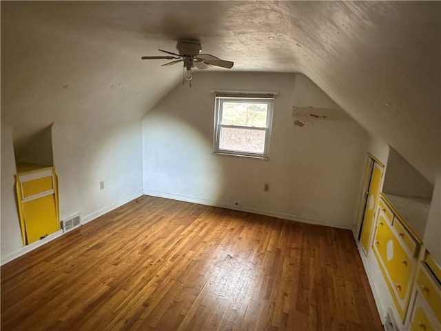 bonus room with hardwood / wood-style floors, ceiling fan, and lofted ceiling