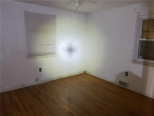 unfurnished room featuring ceiling fan and dark hardwood / wood-style floors