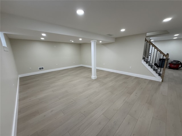 basement with light hardwood / wood-style flooring