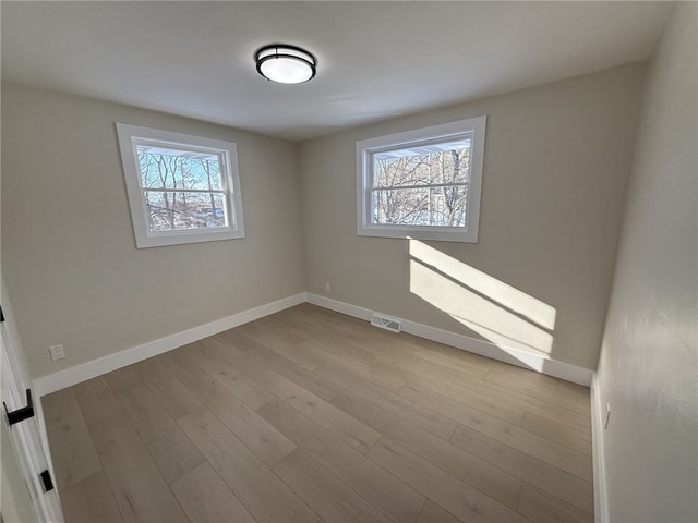 unfurnished room with light hardwood / wood-style flooring