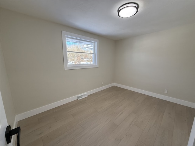 spare room with light hardwood / wood-style floors