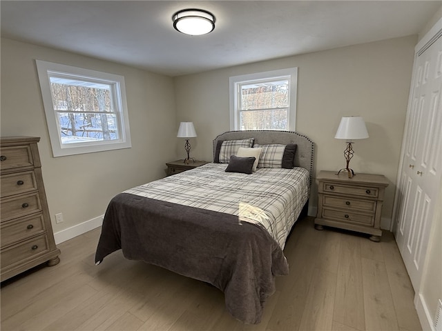 bedroom with a closet and light hardwood / wood-style flooring