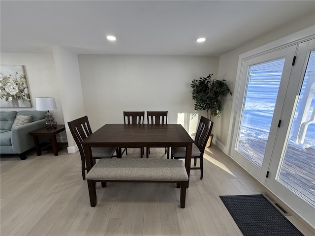 dining area featuring a healthy amount of sunlight and light wood-type flooring