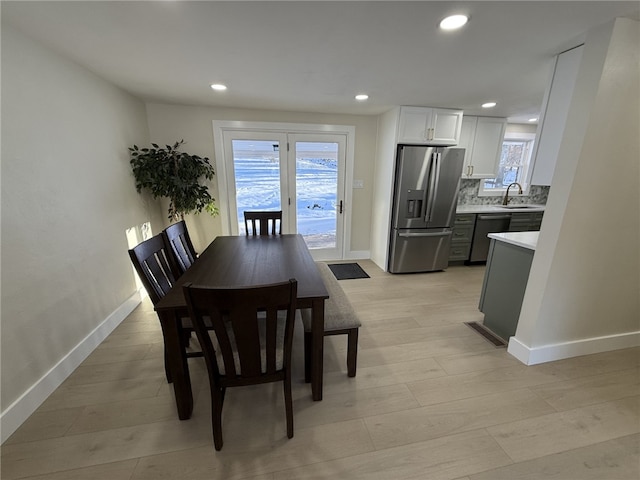 dining area featuring sink and light hardwood / wood-style flooring