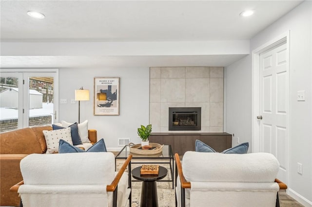 living room with a tile fireplace