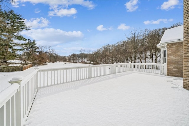 yard covered in snow featuring a wooden deck