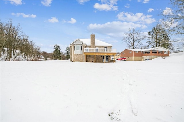 yard covered in snow featuring a wooden deck