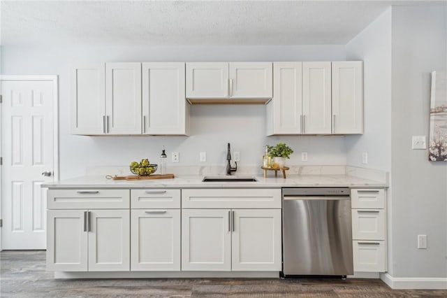 kitchen featuring dark hardwood / wood-style flooring, white cabinetry, dishwasher, and sink