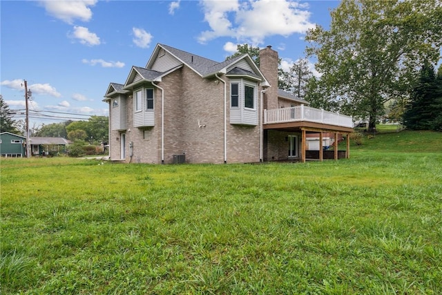 back of house with a yard, central AC, and a wooden deck