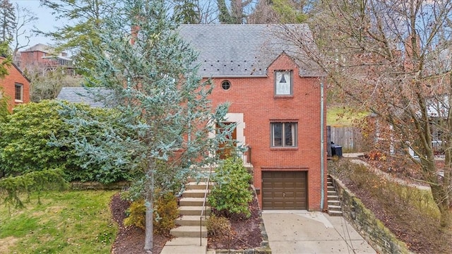 view of front of property with a garage and central AC