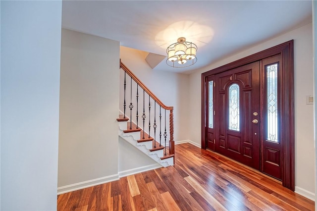 foyer entrance featuring hardwood / wood-style floors and an inviting chandelier