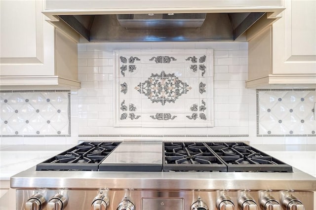 kitchen with decorative backsplash, stove, light stone countertops, and custom range hood