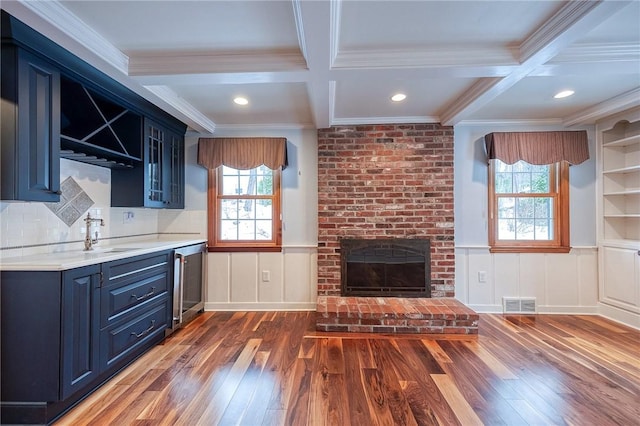 kitchen with a wealth of natural light, sink, and coffered ceiling