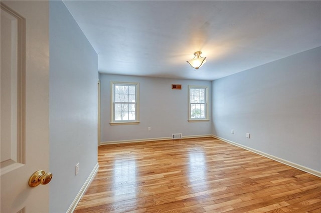 spare room featuring light wood-type flooring