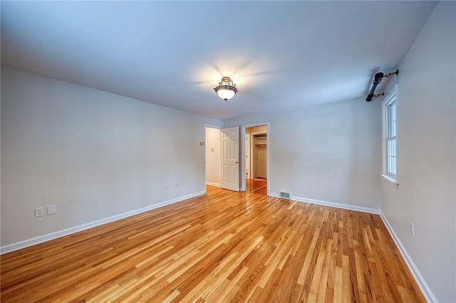 empty room with light hardwood / wood-style floors