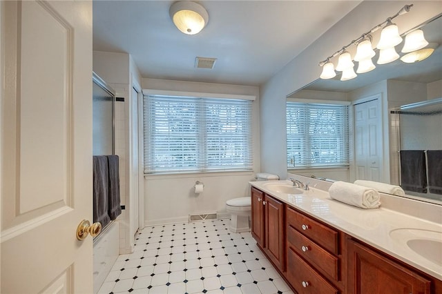 bathroom with vanity, toilet, and walk in shower