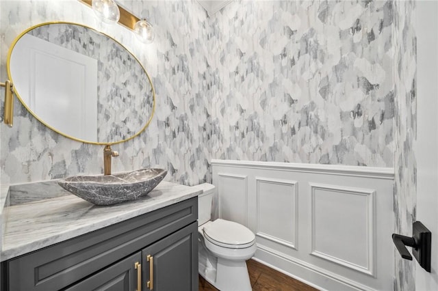 bathroom featuring hardwood / wood-style floors, vanity, and toilet