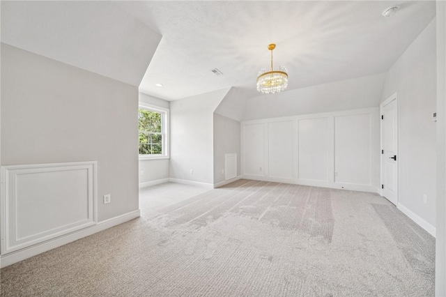 additional living space featuring light colored carpet, an inviting chandelier, and lofted ceiling