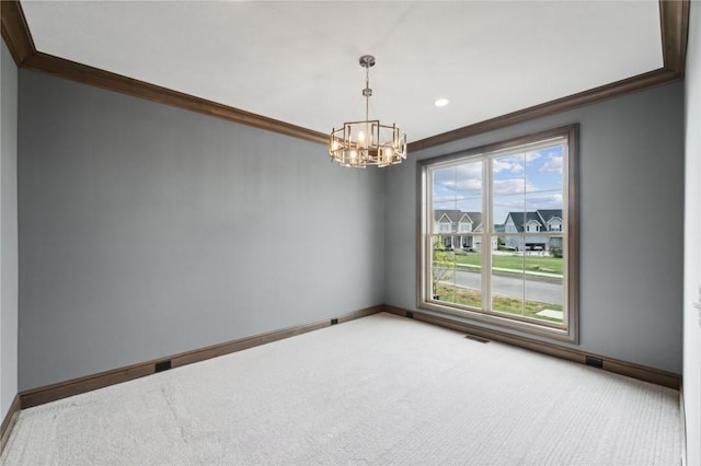 spare room with carpet flooring, a chandelier, and crown molding