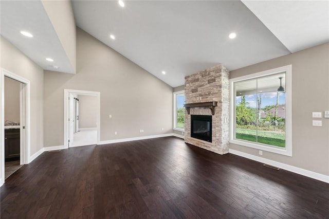 unfurnished living room with a fireplace, dark hardwood / wood-style flooring, and high vaulted ceiling