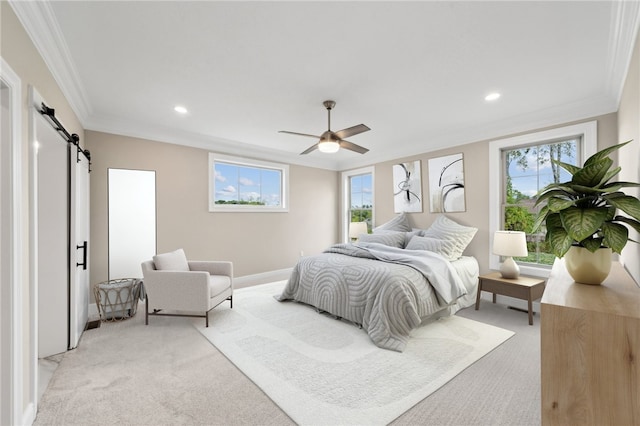 bedroom with ceiling fan, a barn door, crown molding, and light carpet