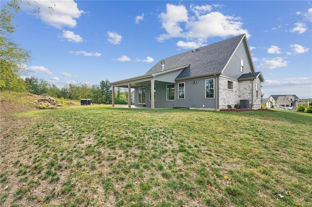 back of house with a yard, cooling unit, and a patio area