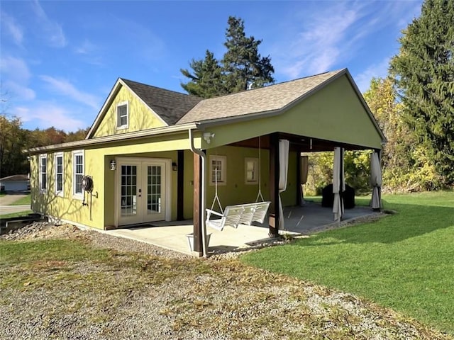 back of property featuring french doors, a patio area, and a lawn