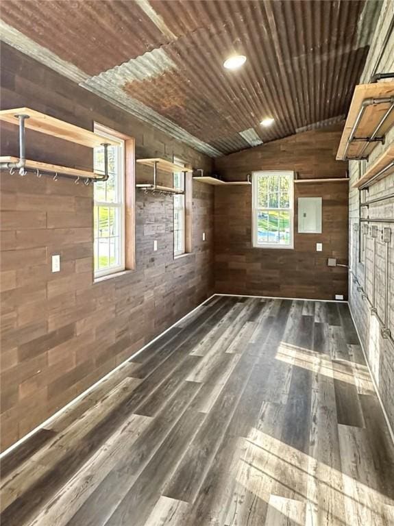 unfurnished room with wood ceiling, wooden walls, dark wood-type flooring, and vaulted ceiling