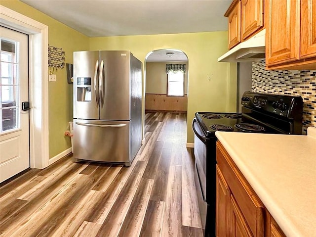 kitchen with dark hardwood / wood-style floors, stainless steel fridge with ice dispenser, backsplash, and black electric range