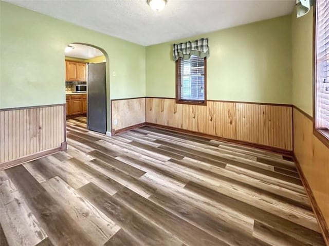 unfurnished room with dark hardwood / wood-style flooring and a textured ceiling