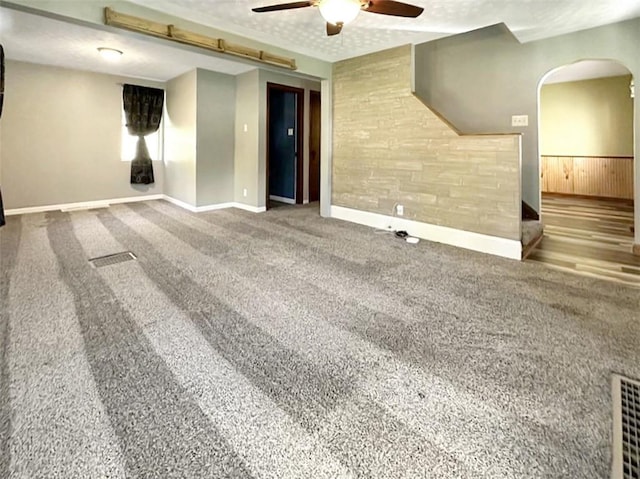 carpeted spare room with ceiling fan and a textured ceiling