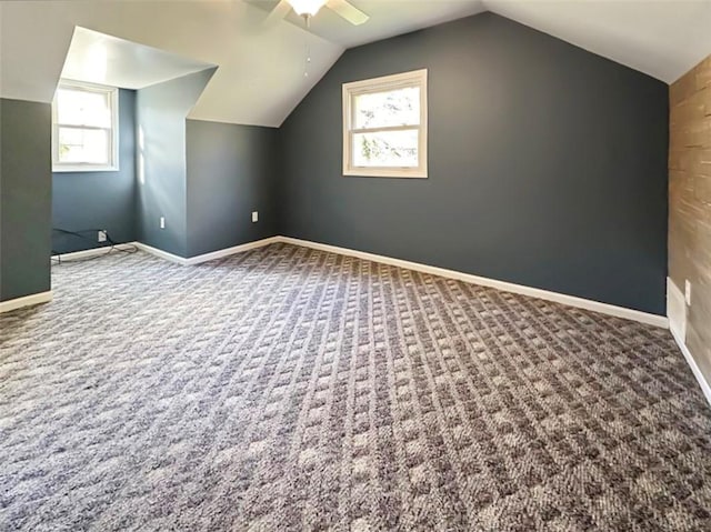 additional living space featuring ceiling fan, carpet, and vaulted ceiling