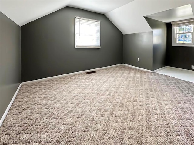 bonus room featuring carpet floors and lofted ceiling