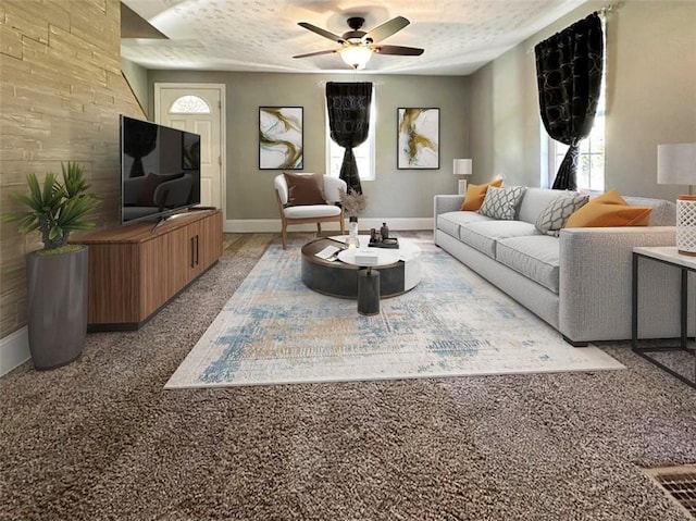 living room featuring carpet, ceiling fan, and a textured ceiling