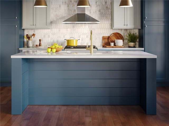 kitchen featuring wall chimney exhaust hood, dark hardwood / wood-style flooring, decorative backsplash, and gray cabinetry