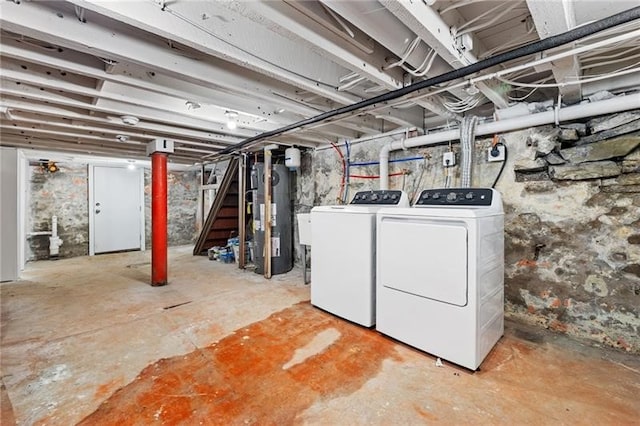 basement featuring water heater and washing machine and clothes dryer