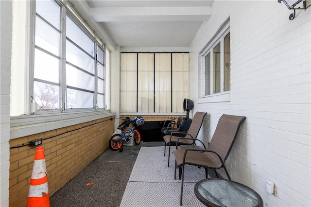 sunroom featuring beamed ceiling