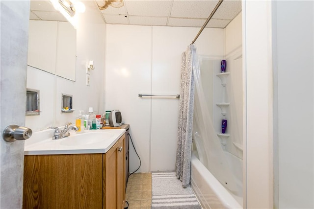 bathroom with vanity, a drop ceiling, and shower / bathtub combination with curtain