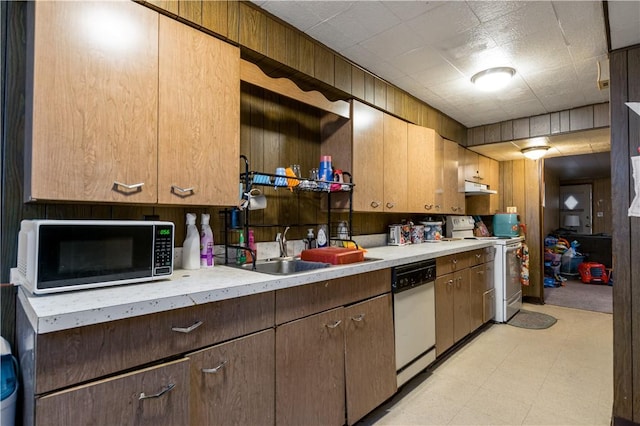 kitchen with wooden walls and white appliances