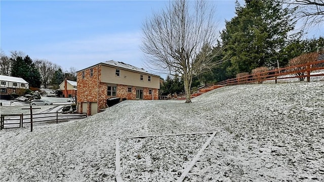 snowy yard with a garage