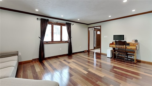 office featuring crown molding, a textured ceiling, and hardwood / wood-style flooring