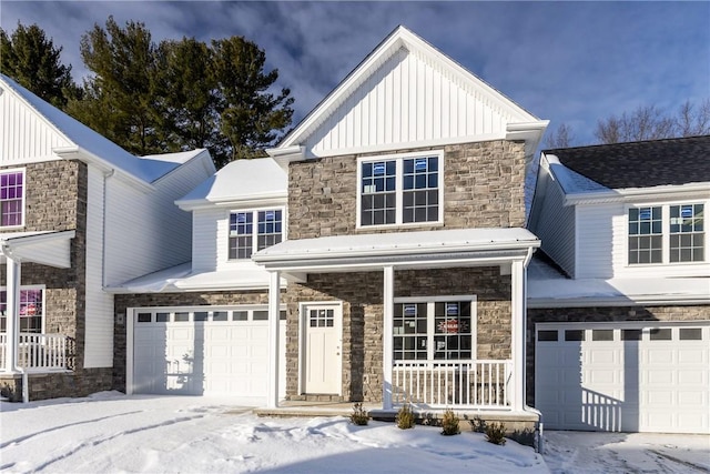 view of front facade featuring a garage, covered porch, stone siding, and board and batten siding